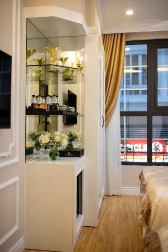a room with a display cabinet with flowers in it at Royal Holiday Hanoi Hotel in Hanoi