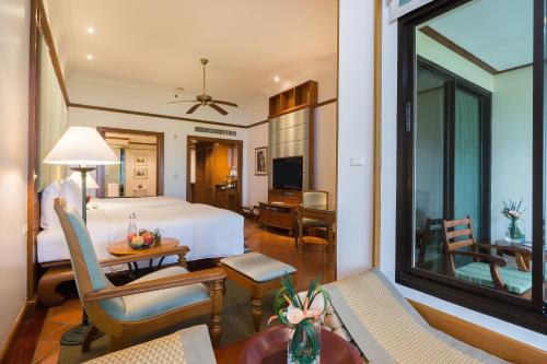 a bedroom with a bed and a living room at JW Marriott Phuket Resort and Spa in Mai Khao Beach