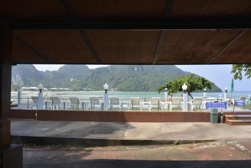 a group of tables and chairs with a view of the water at Phi Phi View Point Resort in Phi Phi Don