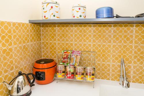 a kitchen counter with an orange toaster and canned food at Le House Boutique Hotel - 100m to the beach in Da Nang