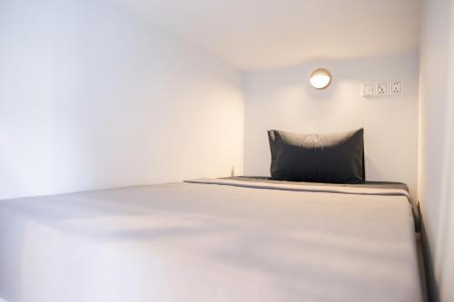 a bed in a room with a pillow on it at The Big Easy Phnom Penh in Phnom Penh