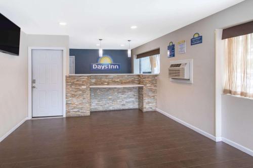 a living room with a fireplace and a tv at Days Inn by Wyndham Elmsford in Elmsford