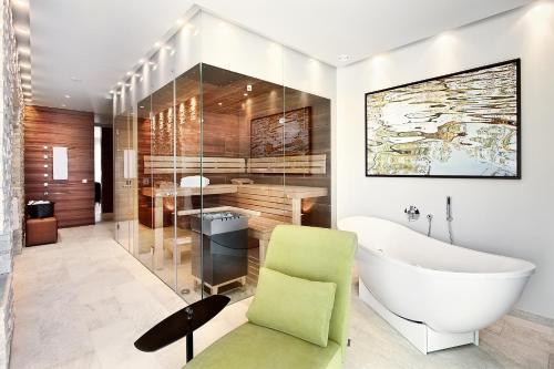 a bathroom with a large tub and a sink at Geinberg5 Private Spa Villas in Geinberg