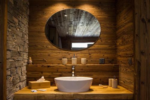 a bathroom with a sink and a mirror at Boutique Lodge Spycher in Saas-Fee