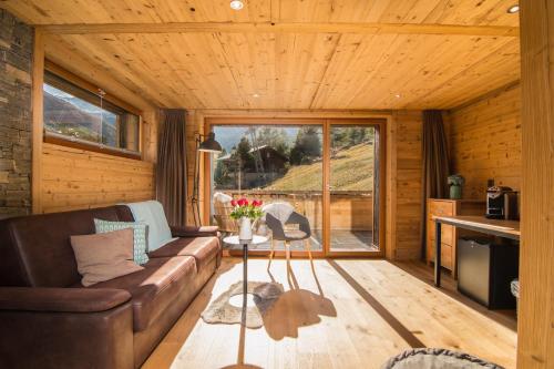 a living room with a couch and a table at Boutique Lodge Spycher in Saas-Fee