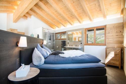 a bedroom with a bed with a cat sleeping on it at Boutique Lodge Spycher in Saas-Fee