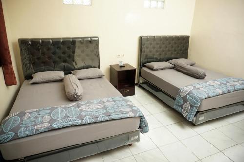 Katil atau katil-katil dalam bilik di Villa Cemara