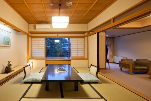 a living room with a table and a couch at Zazan minakami in Minakami