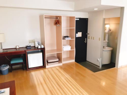 a bathroom with a desk and a toilet in a room at Kagoshima Daiichi Hotel Kishaba in Kagoshima