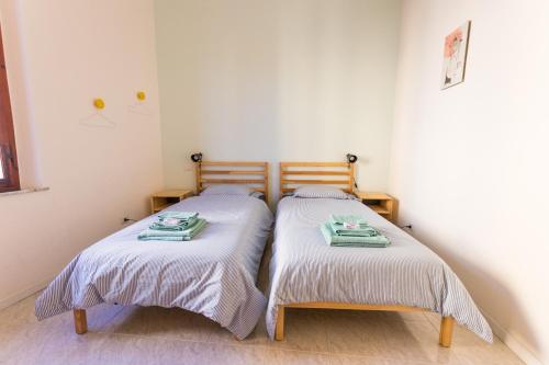 two beds sitting next to each other in a bedroom at Your home in Trequanda in Trequanda