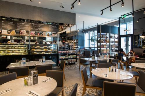 a restaurant with tables and chairs and a bookstore at Dusit Thani Dubai in Dubai