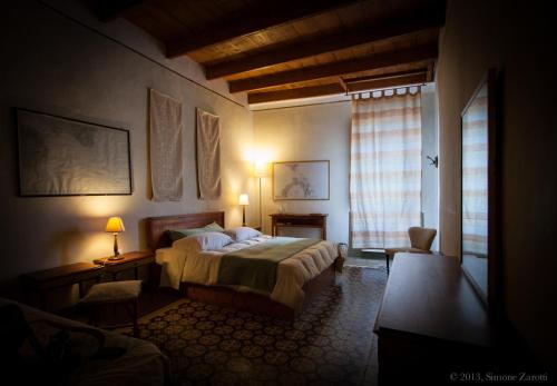 a bedroom with a bed and a window at Piazza San Pantaleo in Sorso