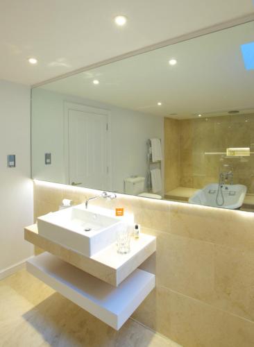 a bathroom with a sink and a large mirror at The Wood Norton in Evesham