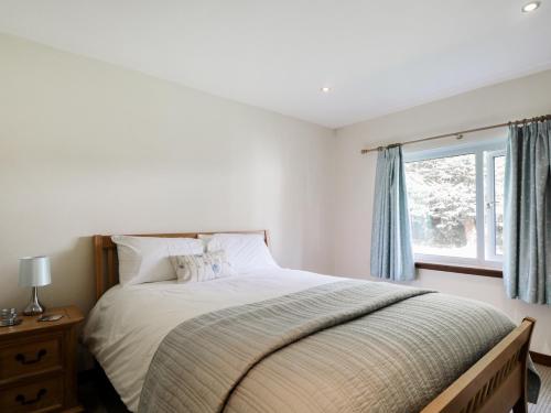 a bedroom with a large bed and a window at St Aethans in Inveran