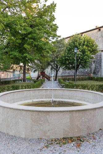 a fountain in the middle of a park at Your home in Trequanda in Trequanda