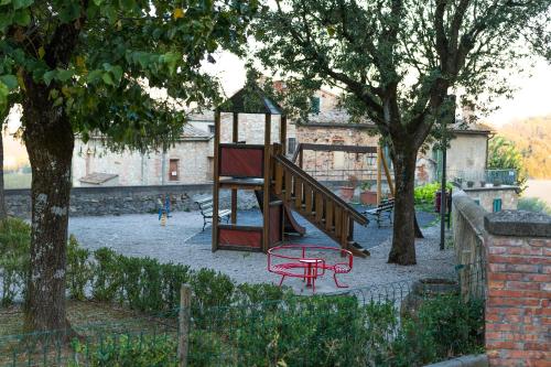 a park with a playground with a bench and trees at Your home in Trequanda in Trequanda
