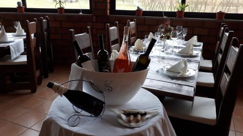 a bottle of wine sitting on a table in a restaurant at Stupnički Dvori Winery Hotel in Brodski Stupnik