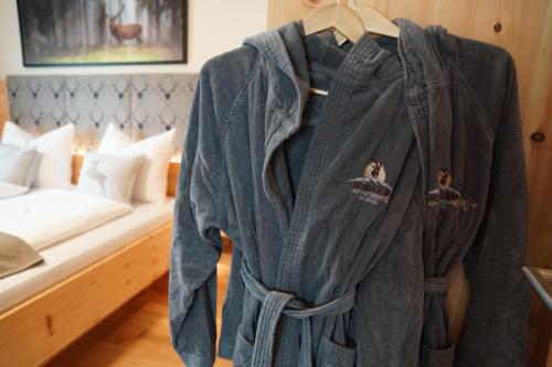 a robe hanging in a room with a bed at Kaiserappartements-Marie in Ellmau