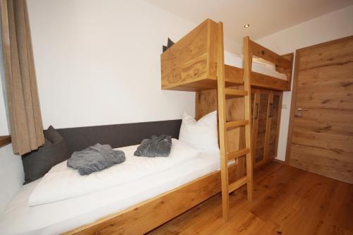 a bunk bed in a room with a ladder at Kaiserappartements-Marie in Ellmau