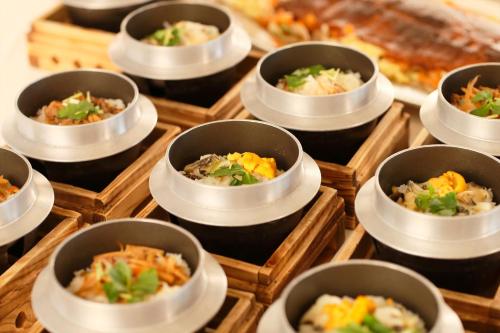 a bunch of small bowls of food on a table at Hotel Hanamaki in Hanamaki