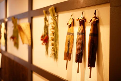 a row of fringeaments hanging on a wall at Hotel Hanamaki in Hanamaki
