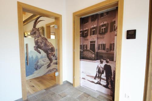 a hallway with a door with a picture of a giraffe at Kaiserappartements-Marie in Ellmau
