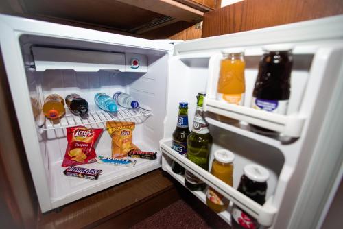 an open refrigerator filled with food and drinks at Maajid Boutique Hotel in Baku