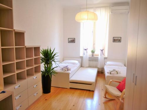 a bedroom with two beds and a window at 3PAPIGE Apartment in Piran
