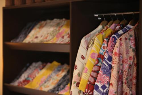 a row of ties are hanging on a rack at Hotel Hanamaki in Hanamaki