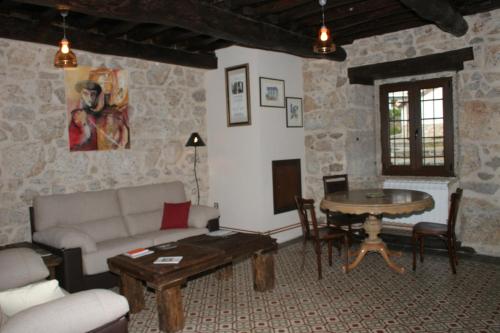 a living room with a couch and a table at Posada Puerta Grande in Candelario