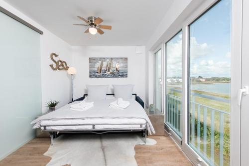 奧本尼茲的住宿－Hamptons Beach House，一间卧室设有一张床和一个大窗户