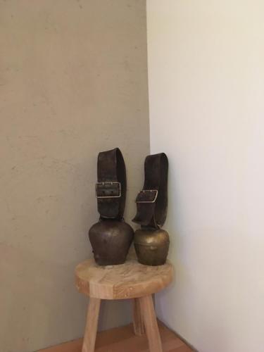 two sculptures sitting on top of a wooden stool at Ferienhof Sonne in Hittisau