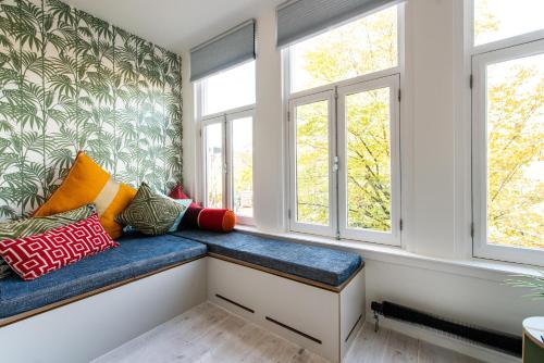 a window seat in a room with pillows at Prinsengracht Canal Studios in Amsterdam