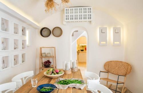 a dining room with a wooden table and chairs at Calumàre in Polignano a Mare