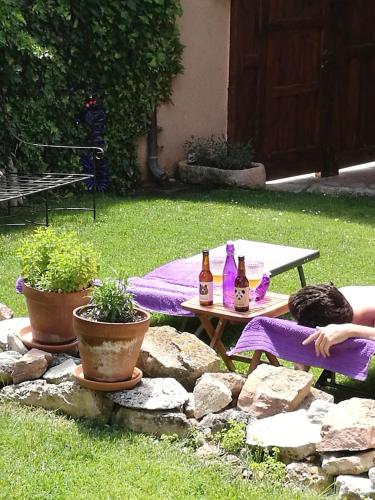 a picnic table with two bottles of beer on it at La Casona de Castilnovo - Gay Men Only in Valdesaz