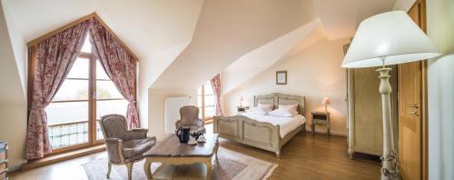 a bedroom with a bed and a large window at Auberge Du Relais Postal in Asselborn