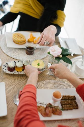 a group of people eating food on a table at Life & Leisure Boutique Guesthouse in Stellenbosch