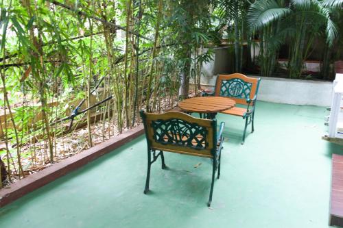 two chairs and a table on a patio at Mrugavani Resort & Spa in Hyderabad