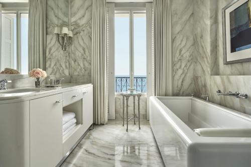 a white bathroom with a tub and a sink at Grand-Hôtel du Cap-Ferrat, A Four Seasons Hotel in Saint-Jean-Cap-Ferrat