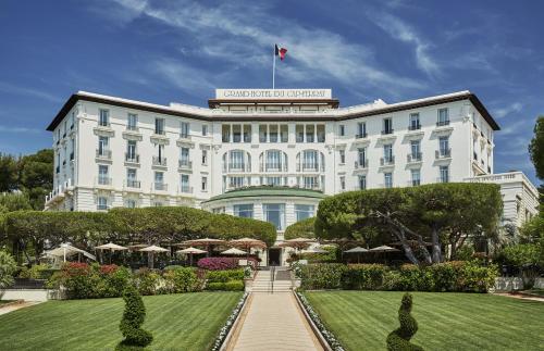 a hotel with a garden in front of it at Grand-Hôtel du Cap-Ferrat, A Four Seasons Hotel in Saint-Jean-Cap-Ferrat