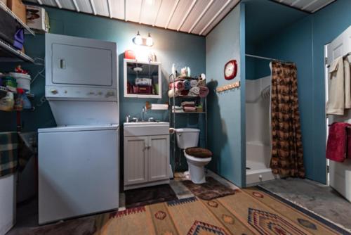 a blue bathroom with a toilet and a sink at Wolf Creek Farm B&B and Motorcycle Manor at Wolf Creek Farm, LLC in Ararat