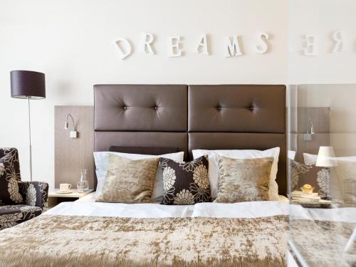 a bedroom with a large bed with a large headboard at Boutiquehotel Stadthalle in Vienna