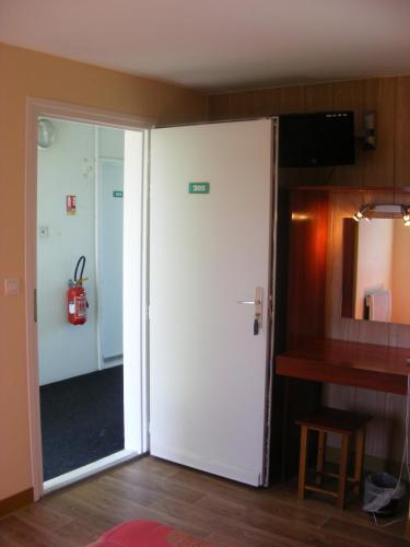 a door leading into a room with a table at Fast Hotel Colmar Houssen in Houssen