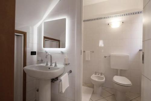 a bathroom with a sink and a toilet and a mirror at Appartamento Piccolo Principe in Monterosso al Mare