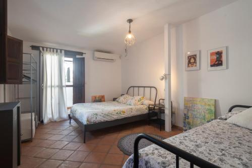 Katil atau katil-katil dalam bilik di Patio del Olivo