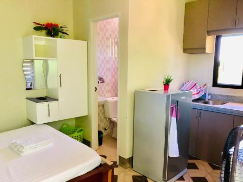 マラパスクア島にあるチャニヴァ ジョイ アイランド ビュー アパートメンツの小さなキッチン(シンク、冷蔵庫付)