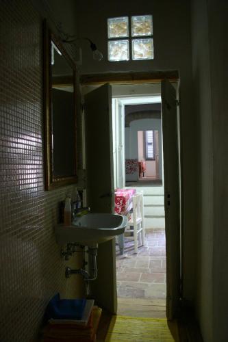 a bathroom with a sink and a mirror at La Neviera Nel Pozzo in Offida