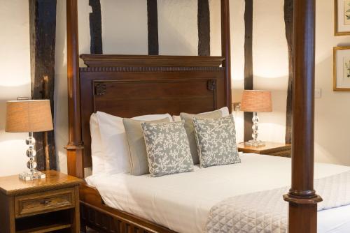 a bedroom with a bed and a night stand at Best Western The Rose & Crown Hotel in Colchester