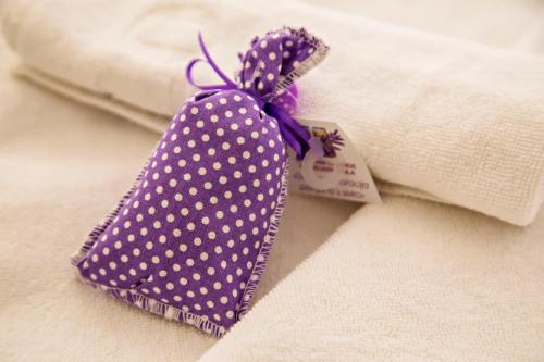 a purple polka dot tie on top of a towel at MEMENTO B&B Piran in Piran