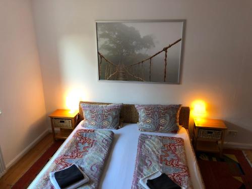 a bedroom with a bed with a bridge picture on the wall at Ferienwohnung im schönen Neuenheim in Heidelberg